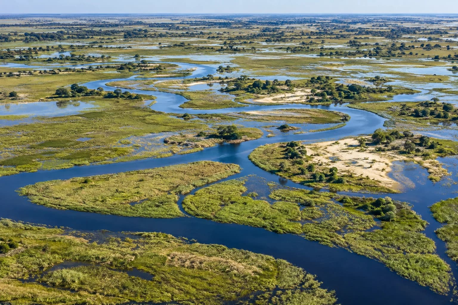 AI-generated illustration: A broad Botswana wetland aerial landscape of sinuous blue channels through green reeds and sandy islands, delicate abstract natural patterns, no animals necessary.