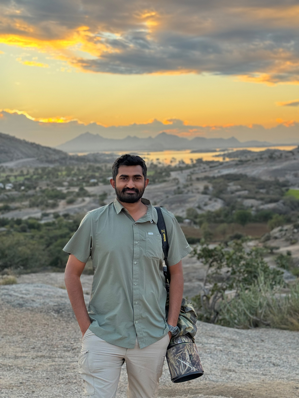 Gaurav Ramnarayanan with his camera in a granite landscape at sunset